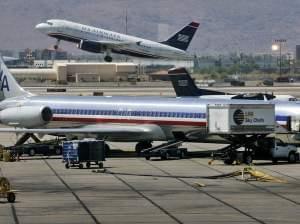 US Airways jet takes off as an American Airlines jet is prepped for takeoff 