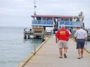 Two men walking on a pier toward a restaurant