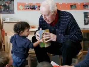 George Willhite reading to toddlers