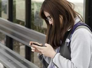 Ruobing Ma, a senior at the University of Illinois at Urbana-Champaign, looks at her cell phone.