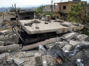 In this photo released by the Syrian official news agency SANA, damaged buildings wrecked by an Israeli airstrike are seen in Damascus, Syria, Sunday, May 5, 2013.
