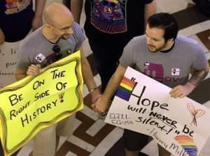 Supporters of Illinois' gay marriage legislation hold hands and sing songs in the rotunda at the Illinois State Capitol Friday, May 31, 2013, in Springfield, Ill. 