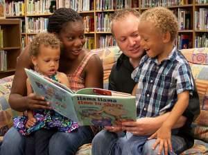 The Barr family reading a book together