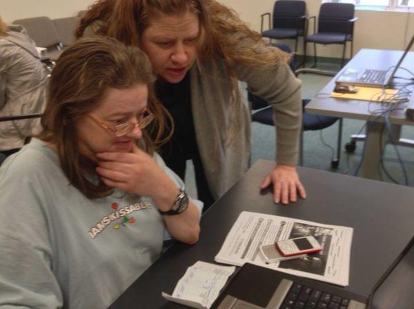 Charlene Aumiller (left) gets help with the health care marketplace from Shannon Killian (right) of the Champaign-Urbana Public Health District on Oct. 1, 2013.