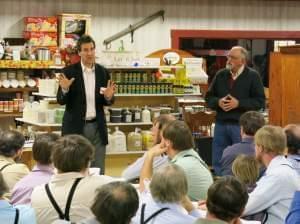 Michael Doherty with the Illinois Farm Bureau, left, speaks with a group of Amish farmers at a recent food hub education meeting. Standing next to him is organizer Dave Bishop. 