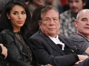 Los Angeles Clippers owner Donald Sterling (center) has been banned by the NBA; he is seen here watching a Clippers game with his girlfriend, V. Stiviano.