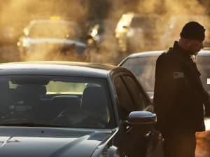 A police officer stands outside the entrance to Sandy Hook Elementary School in Newtown, Conn., on Dec. 15, 2012.