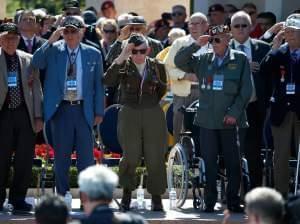 World War II veterans salute as taps is played at a ceremony at the Normandy American Cemetery at Colleville-sur-Mer on Friday, marking the 70th anniversary of D-Day.