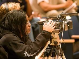 Laina adjusting camera from front row