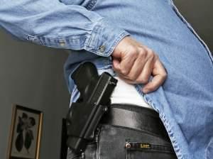 Hank Johnson displays his Glock handgun, inside his home in Springboro, Ohio. D.C. lawmakers had hoped to maintain a ban on carrying handguns in public, but a district court last week overturned it.