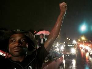 A protestor in front on a convenience store in Ferguson, Mo.