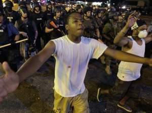 Protesters walk in a line in Ferguson, Mo.