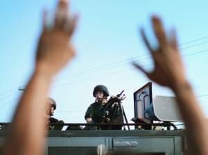 Police stand watch over protesters in Ferguson, Mo. on Aug. 13