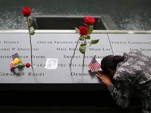 A woman grieves at her husband's memorial at the South Tower Memorial Pool on the 13th anniversary of September 11.