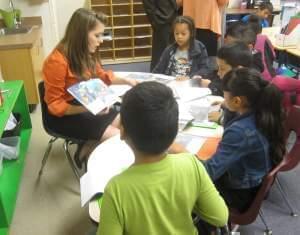 Teacher Kelsey Schoenecke goes through a book with 2nd graders in a dual language immersion class at Urbana's Prairie School.