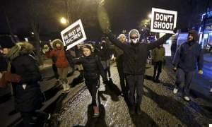 Protesters march during a rally near Chicago Police headquarters Monday night.