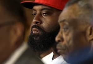 Michael Brown Sr listens alongside Rev. Al Sharpton Tuesday in St. Louis County, Missouri. 