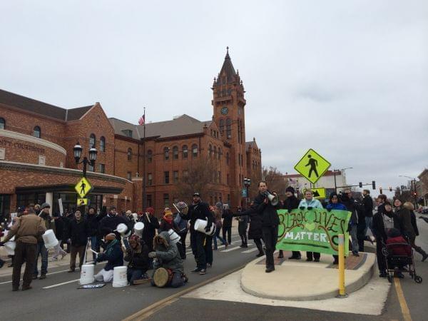 Activists rally outside the Champaign County Courthouse Tuesday in solidarity with those in Ferguson, Missouri.