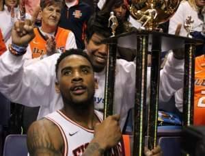 Illinois basketball player Rayvonte Rice, hoisting the Braggin' Rights Trophy with his mother, Rhonda Rice.