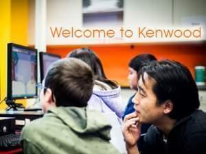 Students looking at a computer on a desk