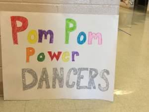 Hand-painted sign saying Pom Pom Power Dancers