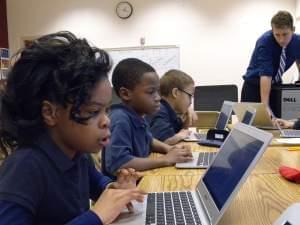 Young students working at computers in a school computer lab