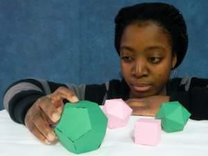 Student Sonie Toe examines polyhedra made from paper