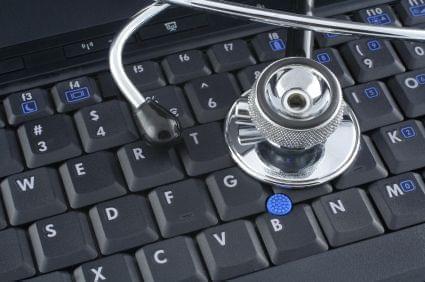 a stethoscope sitting on a computer keyboard