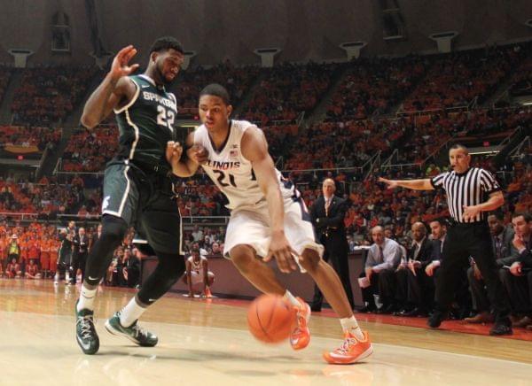 Illini Malcolm Hill drives against Michigan State Spartan Branden Dawson