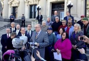 Illlinois AFL-CIO President Michael Carrigan is joined by state workers outside the Illinois Supreme Court.