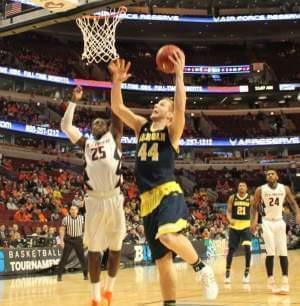 Peoria native Max Bielfeldt lays the ball in for Michigan during the Illini's 73-55 loss.