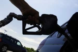 A motorist puts fuel in his car.