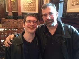 Daniel Gorog, a man with autism stands next to his father, Dan Gorog, who address a Senate committee Tuesday.