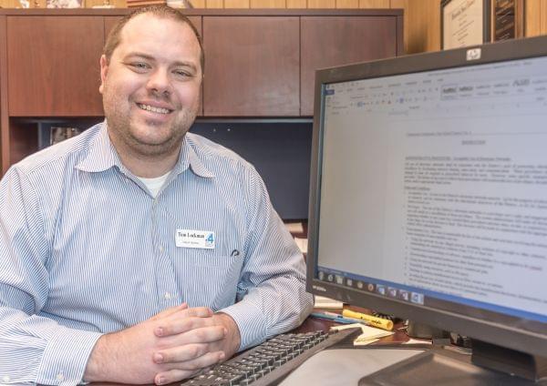 Champaign Unit 4 school district attorney Tom Lockman with a screen of some of the district's digital media policies in his office in Champaign on Wednesday, April 1, 2015. 