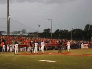 Illinois players wait to congratulate first baseman David Kerian after his three-run homer against Ohio Friday.  Illinois won the game, 10-3.