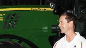 Illinois Congressman Rodney Davis stands alongside John Deere farm equipment during a tour of the AgReliant Genetics Champaign Research Station near Ivesdale. 