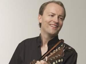 A man playing a mandolin