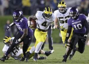 In this Nov. 8, 2014 file photo Michigan running back De'Veon Smith runs against Northwestern during a game in Evanston, IL.