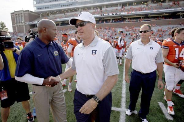 Illinois interim head coach Bill Cubit, right, shakes hands with Kent State head coach Paul Haynes at the end of Illinois' 52-3 victory Saturday in Champaign