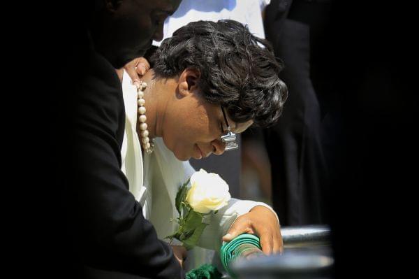 Sandra Bland's sister Sharon Cooper kneels at Bland's burial site at the Mt. Glenwood Memorial Gardens West cemetery Saturday, July 25, 2015, in Willow Springs, Ill.