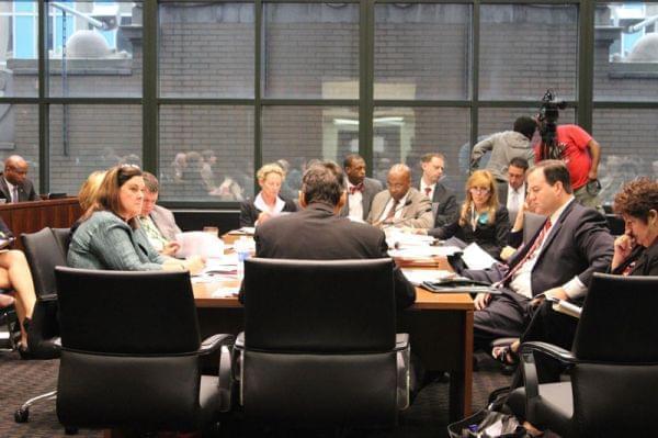 Legislators and union leaders negotiating in a conference room