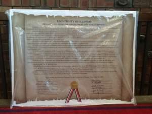 The U of I's ten trustees signed a giant cardboard declaration meant to urge the governor and lawmakers to end the state's budget standoff that's blocked funding from the U of I and other state universities.