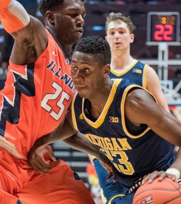 Michigan's guard Caris LeVert (23) drives into Illinois' guard Kendrick Nunn (25) during the second half of Michigan's 78-68 win over Illinois.