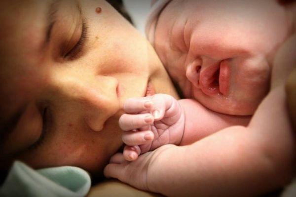 Christine Herman holds her daughter moments after her birth