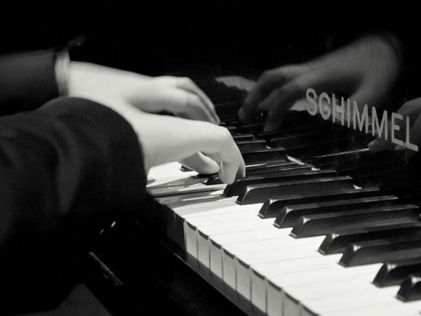 up close of fingers playing piano