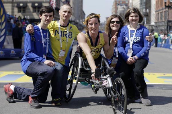 Tatyana McFadden, of Clarksville, Md., center, winner of the women's wheelchair division of the 120th Boston Marathon, poses with the family of 2013 bombing victim Martin Richard, on Monday, April 18, 2016, in Boston. From left Henry and Bill Ri