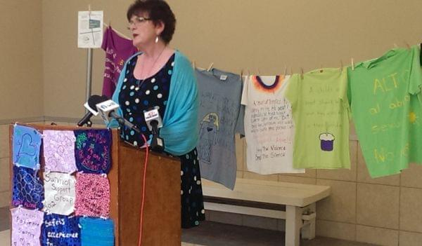 RACES Executive Director Mary Evans addresses reporters outside her agency's Urbana office Thursday.