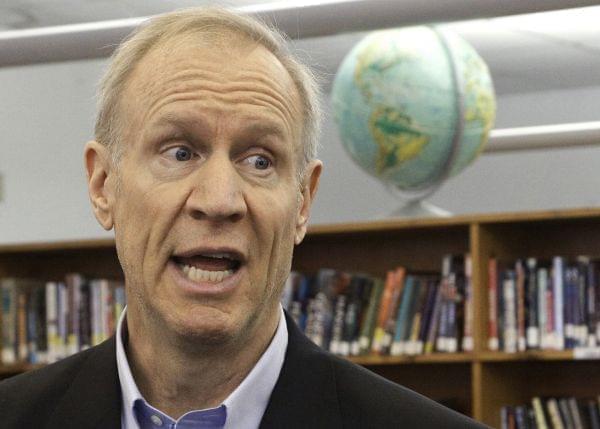 In this Wednesday, May 11, 2016 photo, Illinois Gov. Bruce Rauner visits with students at New Berlin High School in New Berlin, Ill. Rauner's vision of a grand, two-year budget compromise with Illinois lawmakers is becoming more difficult to acc