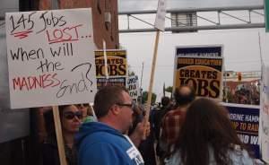 Demonstrators marched outside the office of State Representative Norine Hammond in Macomb, demanding she vote to fully fund higher education.