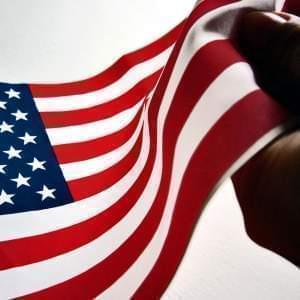 Hand clasping an American flag